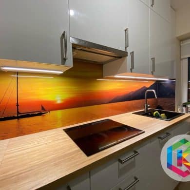 Realizacja panelu szklanego w kuchni z motywem zachodu słońca, prezentująca unikalny design i atmosferę, którą można osiągnąć dzięki tym panelom.